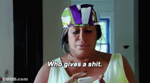 Woman In Colorful Hat Holding Cell Phone Saying Who Gives A Shit GIF