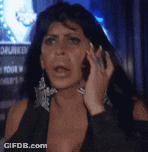 Woman In Colorful Hat Holding Phone Saying Who Gives A Shit GIF