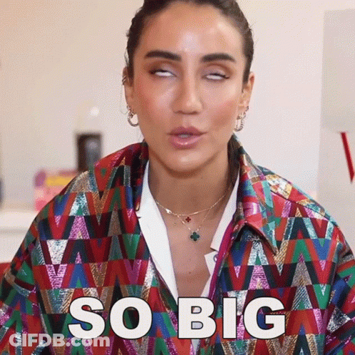 Woman In Colorful Jacket Making Funny Face Saying So Big GIF