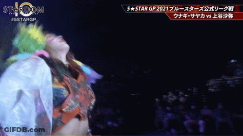 Woman In Colorful Outfit Dancing At 5 Star GP Sign GIF