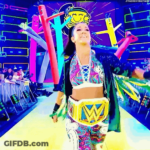 Woman In Colorful Outfit Walking Runway With Wrestling Belt GIF