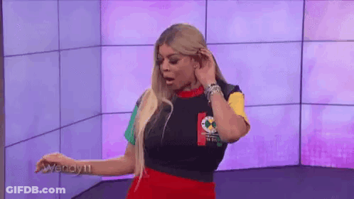 Woman In Colorful Shirt At Purple Wall GIF