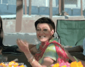 Woman In Colorful Shirt Clapping And Smiling GIF