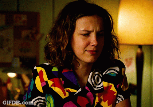 Woman In Colorful Shirt Sitting With Lamp GIF