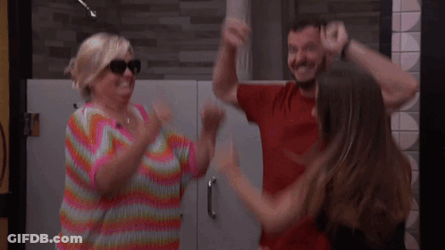 Woman In Colorful Sweater Dancing With Man And Woman GIF