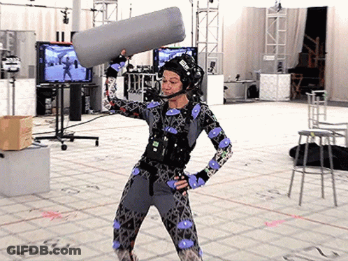 Woman In Costume Holding Microphone With E Helmet GIF