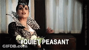 Woman In Costume Sitting At Table With Martini Saying Quiet Peasant GIF
