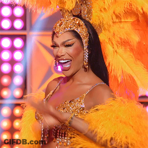 Woman In Costume With Feathers And Rhinestones Smiling GIF