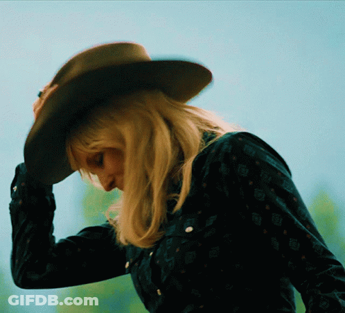 Woman In Cowboy Hat And Black Shirt Looking Down GIF