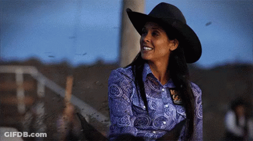 Woman In Cowboy Hat And Blue Shirt With Texas Badge GIF