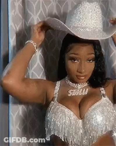 Woman In Cowboy Hat And Bra By Curtain GIF