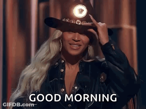 Woman In Cowboy Hat And Leather Jacket Saying Good Morning GIF