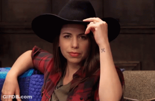 Woman In Cowboy Hat And Plaid Shirt With Wrist Tattoo GIF
