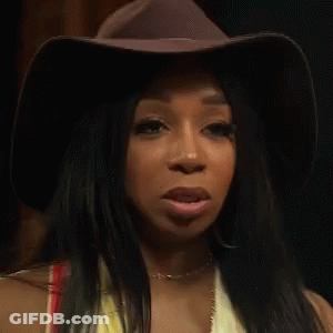Woman In Cowboy Hat And Yellow Top Making A Face GIF
