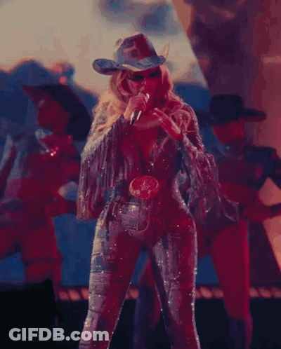 Woman In Cowboy Hat Singing On Stage GIF
