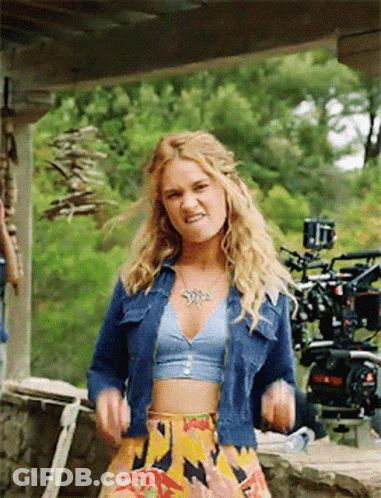 Woman In Crop Top And Denim Jacket GIF