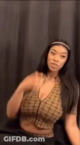 Woman In Crop Top And Headband Sitting On Bed GIF