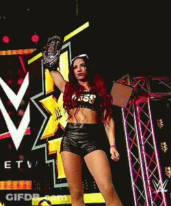 Woman In Crop Top And Shorts Holding Wrestling Glove GIF