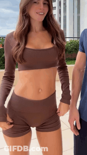 Woman In Crop Top And Shorts Next To Man GIF