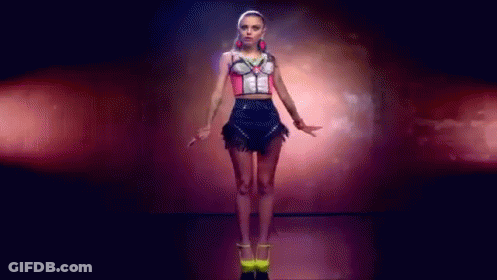 Woman In Crop Top And Skirt Dancing In Dark Room GIF