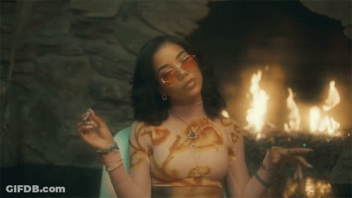 Woman In Crop Top And Sunglasses At Fireplace GIF