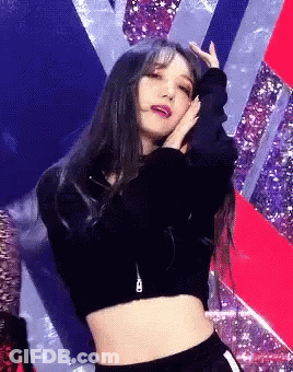 Woman In Crop Top Dancing On Stage With Hands On Head GIF