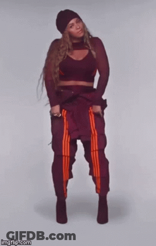 Woman In Crop Top Dancing With Crossed Legs GIF