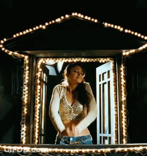 Woman In Crop Top Standing In Window With Lights GIF