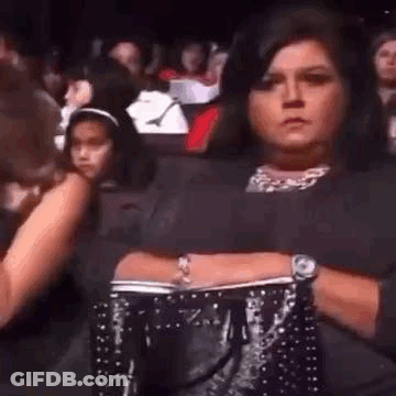 Woman In Crowd Arms Crossed Holding Purse GIF