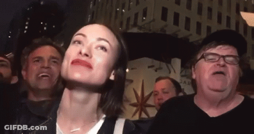 Woman In Crowd Looking Up GIF