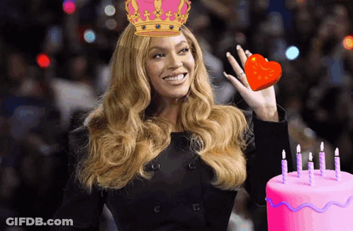 Woman In Crown Holding Heart Next To Birthday Cake GIF
