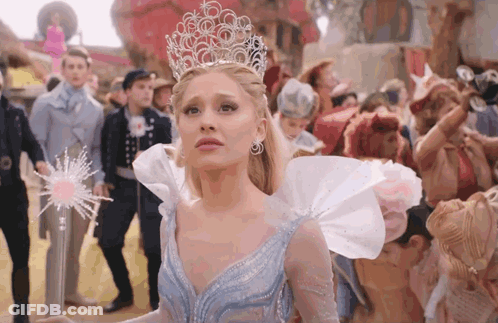 Woman In Crown Holding Wand Before Crowd GIF