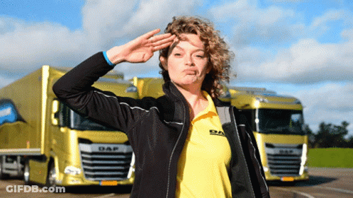 Woman In Daf Shirt Saluting In Front Of Yellow Truck GIF