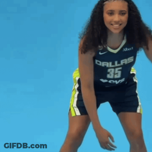 Woman In Dallas Jersey Holding Ball GIF