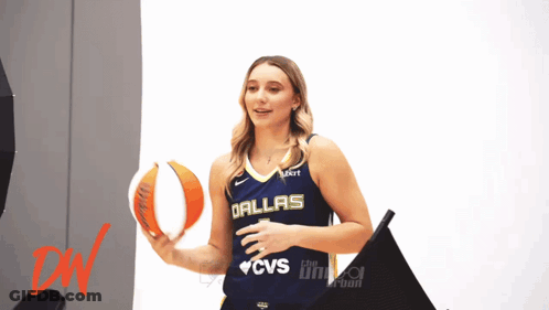 Woman In Dallas Jersey Holding Basketball GIF