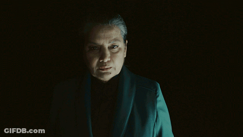 Woman In Dark Room Asking What Are You Prepared To Do For Me GIF