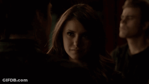 Woman In Dark Room Looking At Man GIF