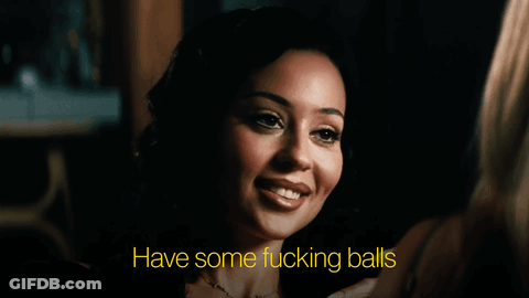Woman In Dark Room Saying Have Some Fucking Balls GIF