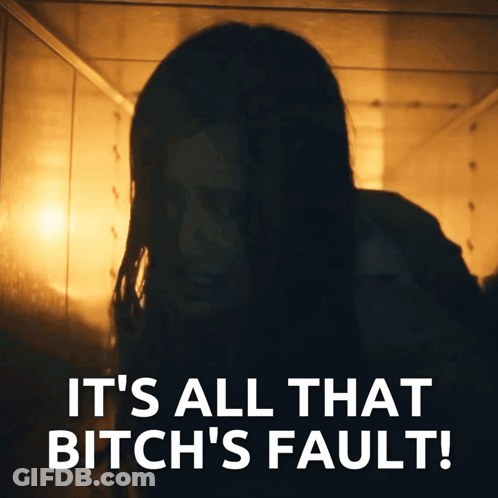 Woman In Dark Room Saying It's All That Bitch's Fault GIF