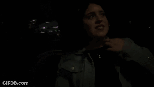 Woman In Dark Room Saying Its Funny GIF