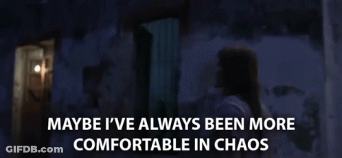 Woman In Dark Room Saying Maybe I've Always Been More Comfortable In Chaos GIF