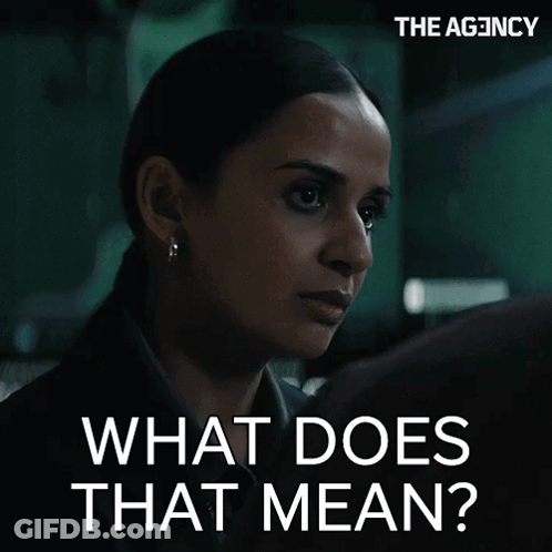 Woman In Dark Room Saying What Does That Mean GIF