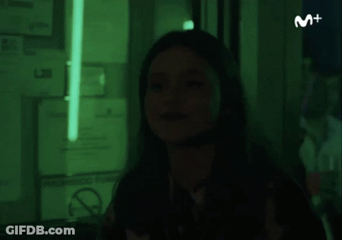 Woman In Dark Room With Green Light And No Smoking Sign GIF