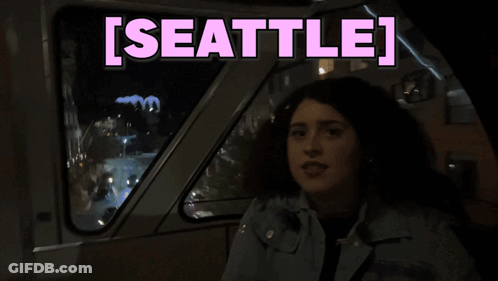 Woman In Dark Room With Seattle In Pink GIF