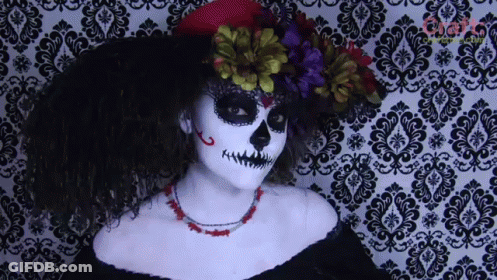 Woman In Day Of The Dead Costume In Front Of Damask Wall GIF
