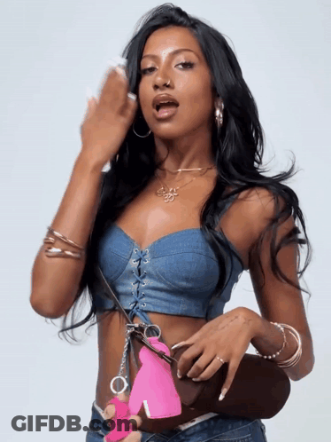 Woman In Denim Crop Top Holding Pink Handcuff GIF