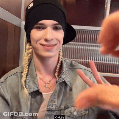 Woman In Denim Jacket And Black Hat With Letter O Making Peace Sign GIF
