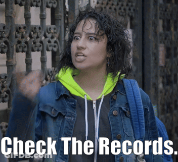 Woman In Denim Jacket And Neon Green Hoodie Says Check The Records GIF