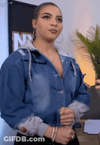 Woman In Denim Jacket At NY Sign GIF