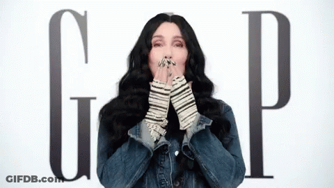 Woman In Denim Jacket Blowing A Kiss Gap Sign GIF
